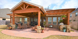 Custom covered patio with arbor, outdoor living area created by Backyard Retreats